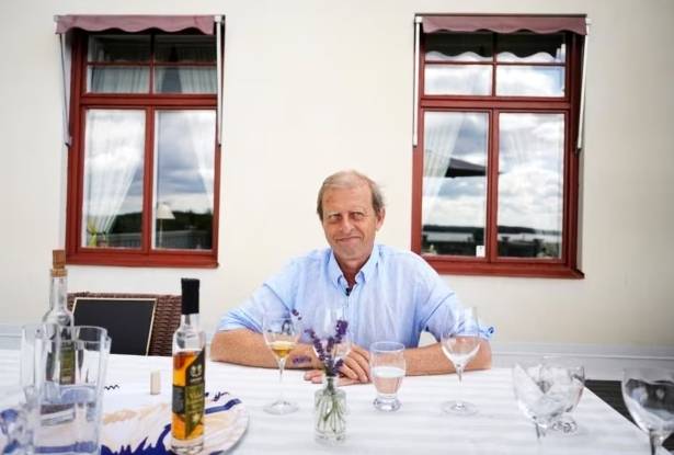 Göran Amnegård, owner of Blaxsta wine, smiles during wine testing in Flen